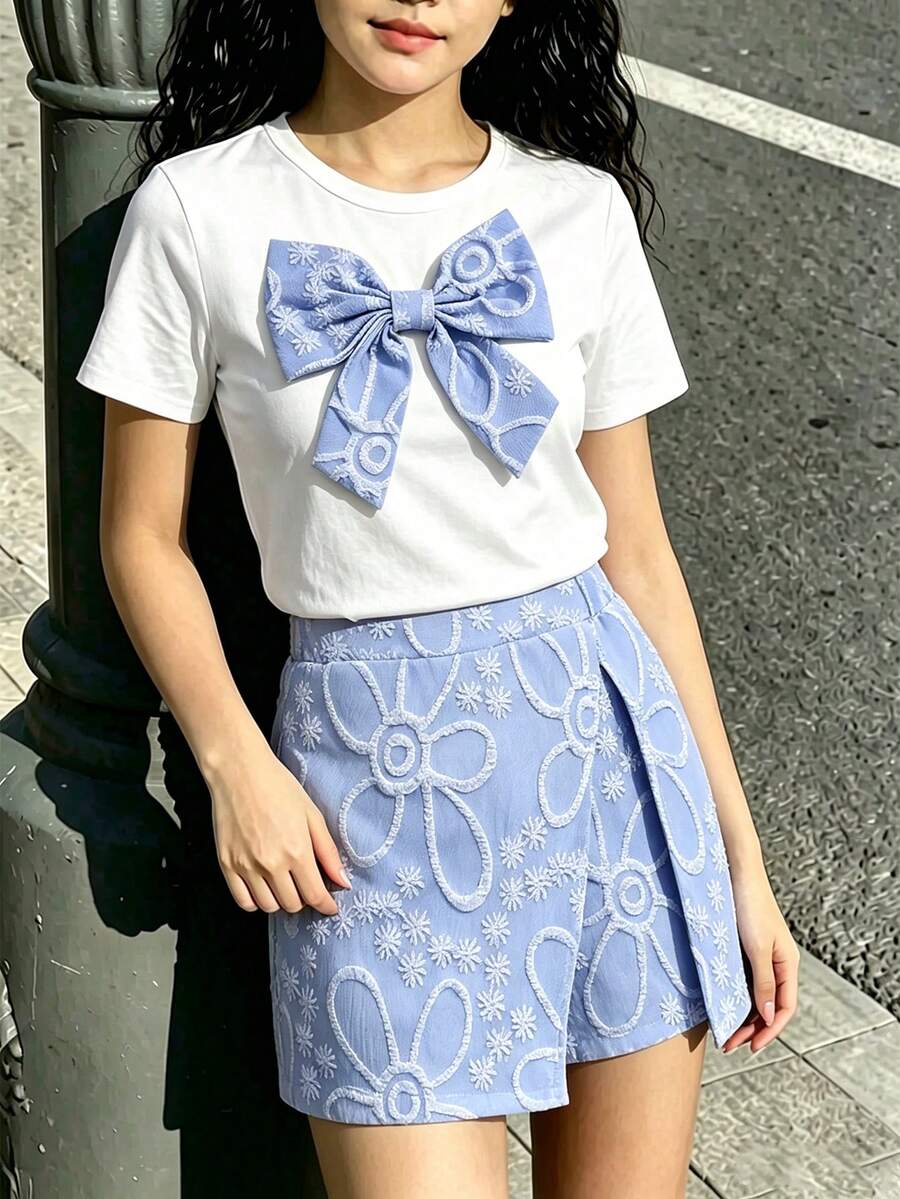 Tween girls 2-piece blue outfit featuring a short sleeve round neck t-shirt with a bow front detail and an asymmetric wrap skort.