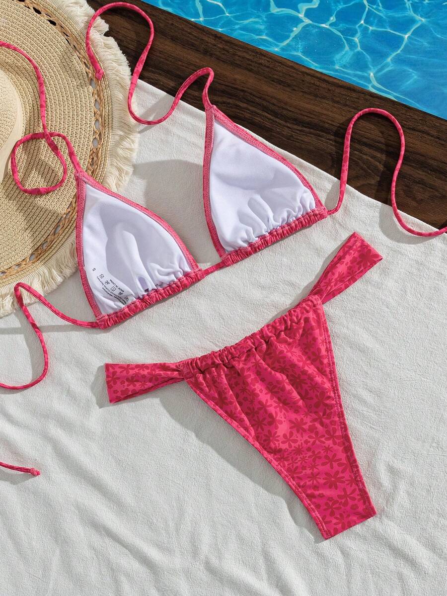 Women's striped halter two-piece swimsuit featuring a lace-up triangle top with removable padding and high-cut low-waist bikini bottoms.