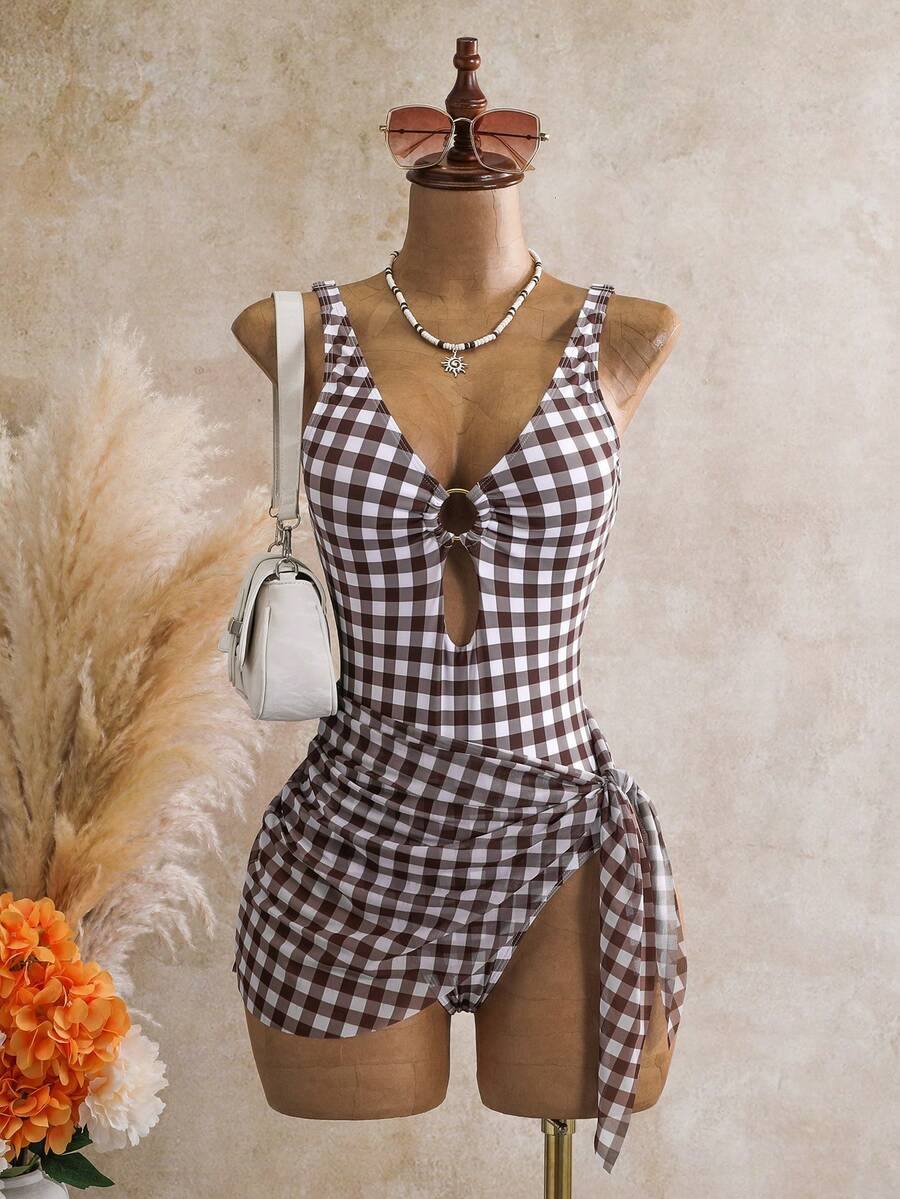 Women's black floral print plunge neck one-piece swimsuit featuring cut-out detail paired with a matching knee-length mesh cover-up skirt
