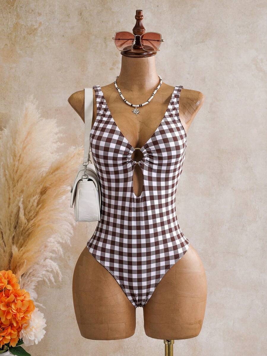 Women's black floral print plunge neck one-piece swimsuit featuring cut-out detail paired with a matching knee-length mesh cover-up skirt