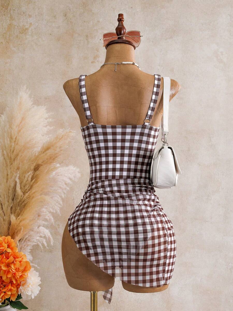 Women's black floral print plunge neck one-piece swimsuit featuring cut-out detail paired with a matching knee-length mesh cover-up skirt