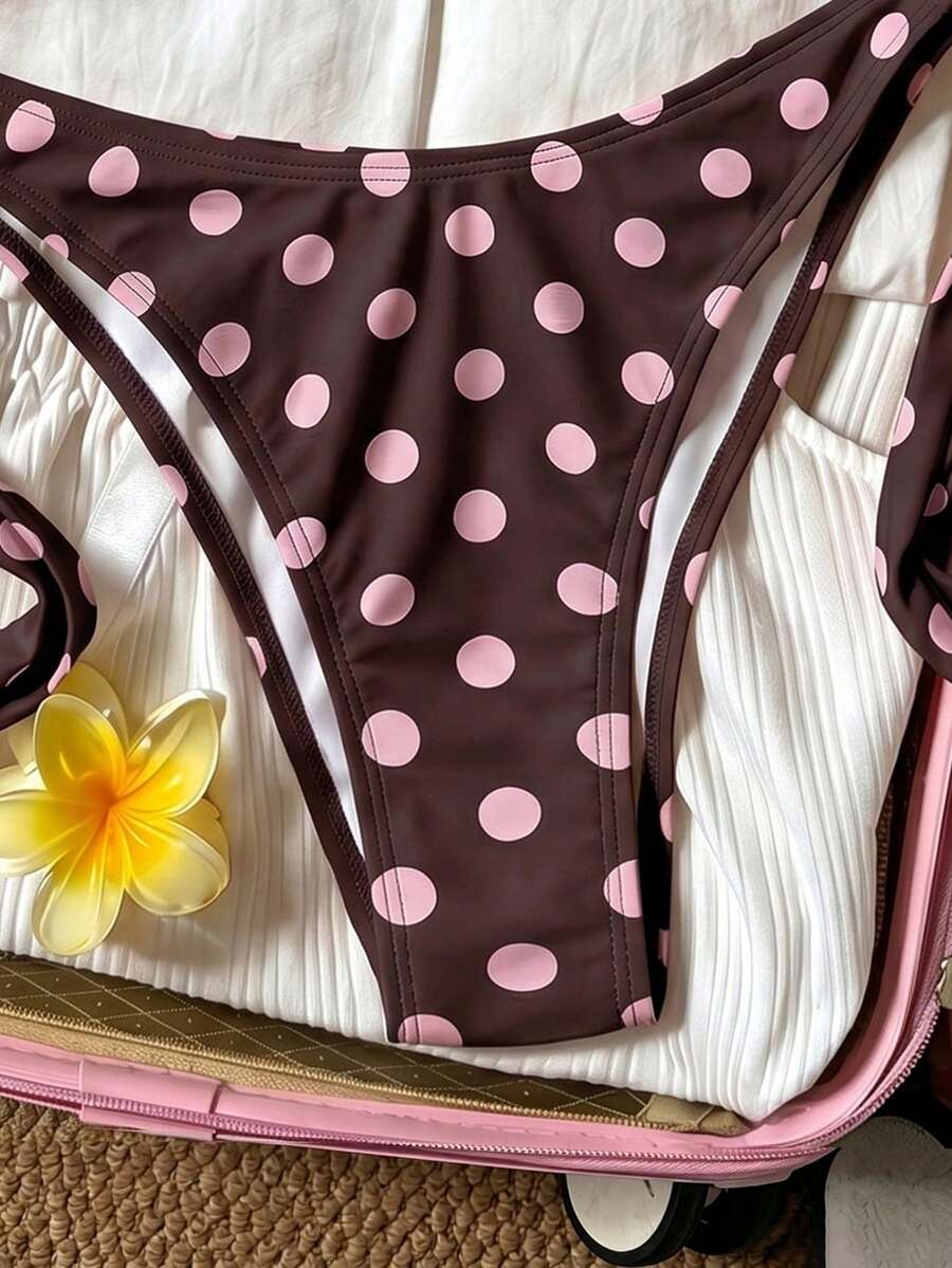 Women's polka dot two-piece bikini set featuring a backless halter top with triangle cups and matching tie-side bottoms.