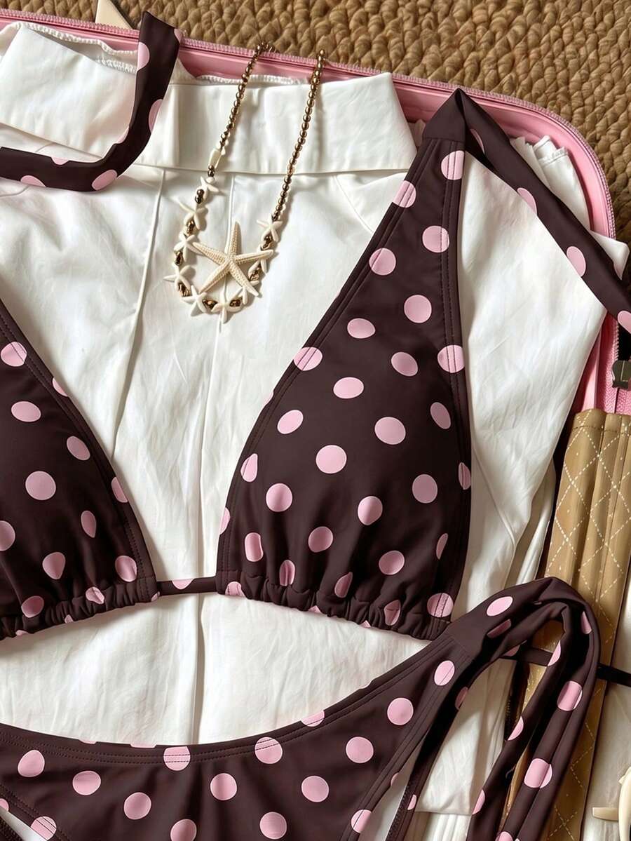 Women's polka dot two-piece bikini set featuring a backless halter top with triangle cups and matching tie-side bottoms.