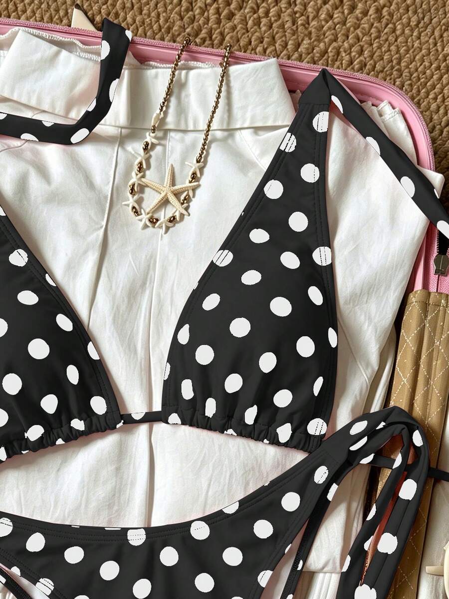 Women's polka dot two-piece bikini set featuring a backless halter top with triangle cups and matching tie-side bottoms.