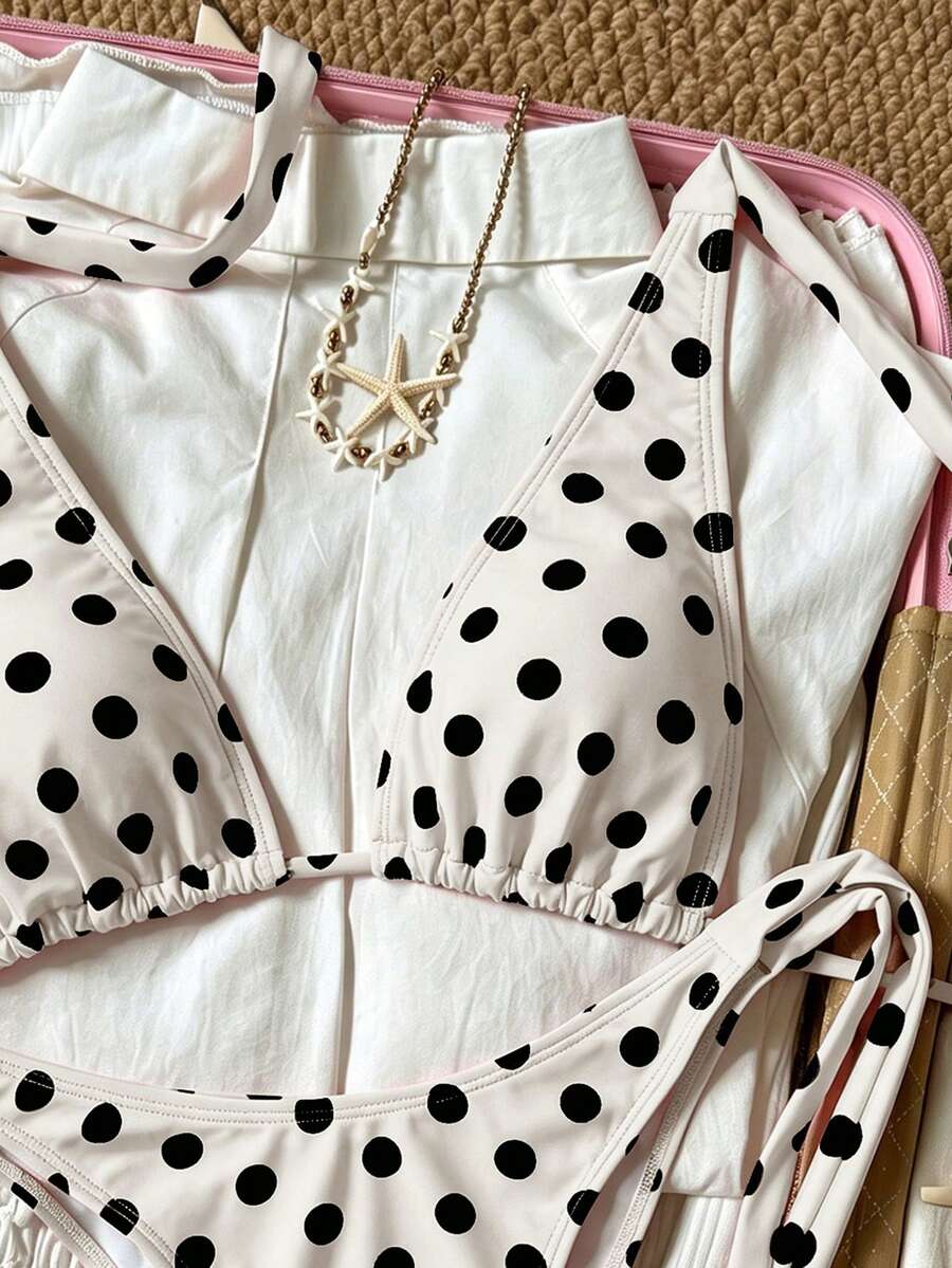 Women's polka dot two-piece bikini set featuring a backless halter top with triangle cups and matching tie-side bottoms.