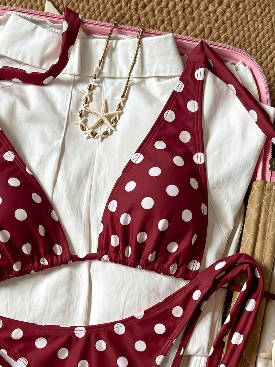 Women's polka dot two-piece bikini set featuring a backless halter top with triangle cups and matching tie-side bottoms.