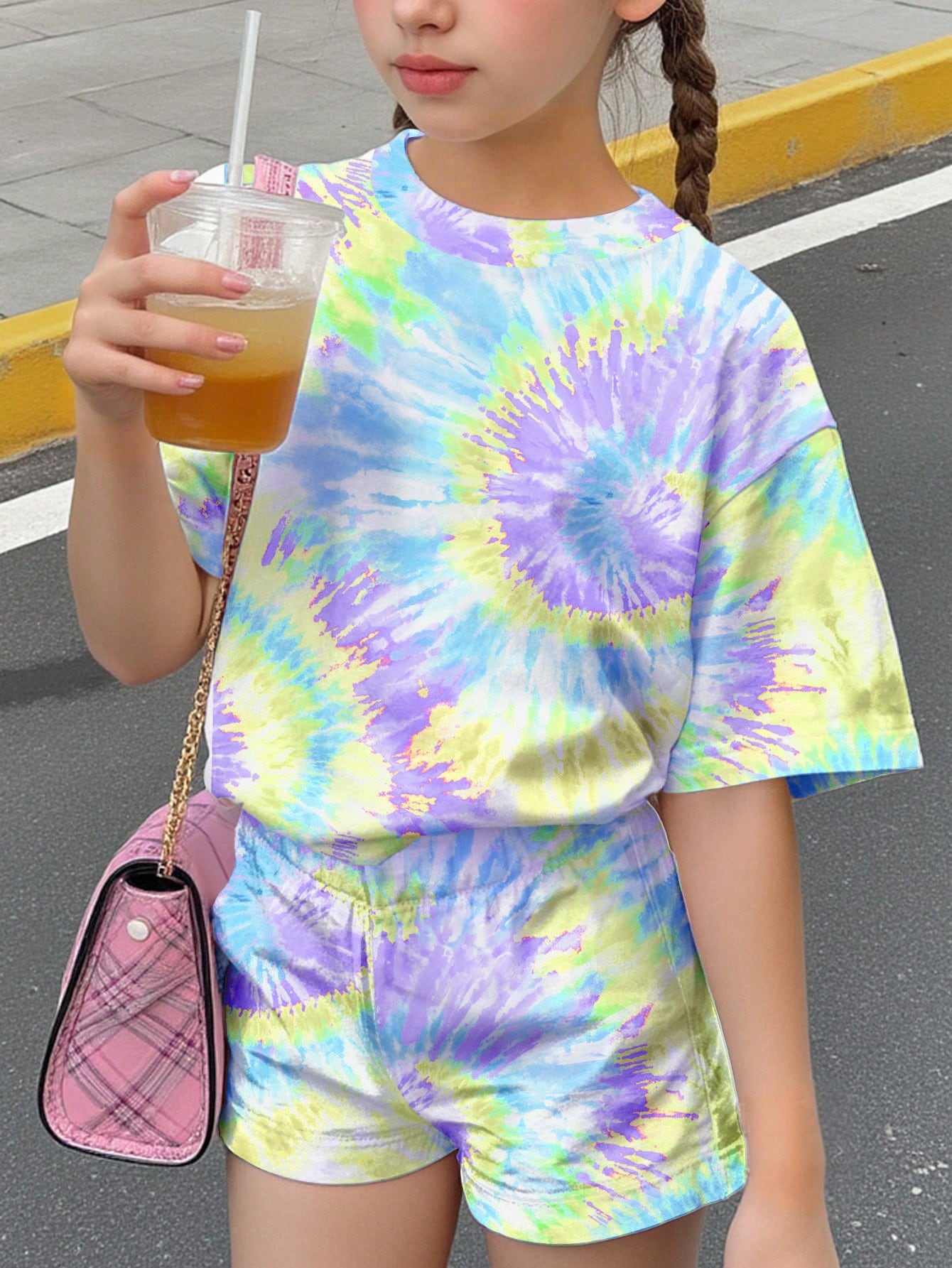 Tween girls multicolor tie-dye 2-piece outfit set featuring a drop-shoulder short-sleeve t-shirt and matching loose track shorts with side pockets.