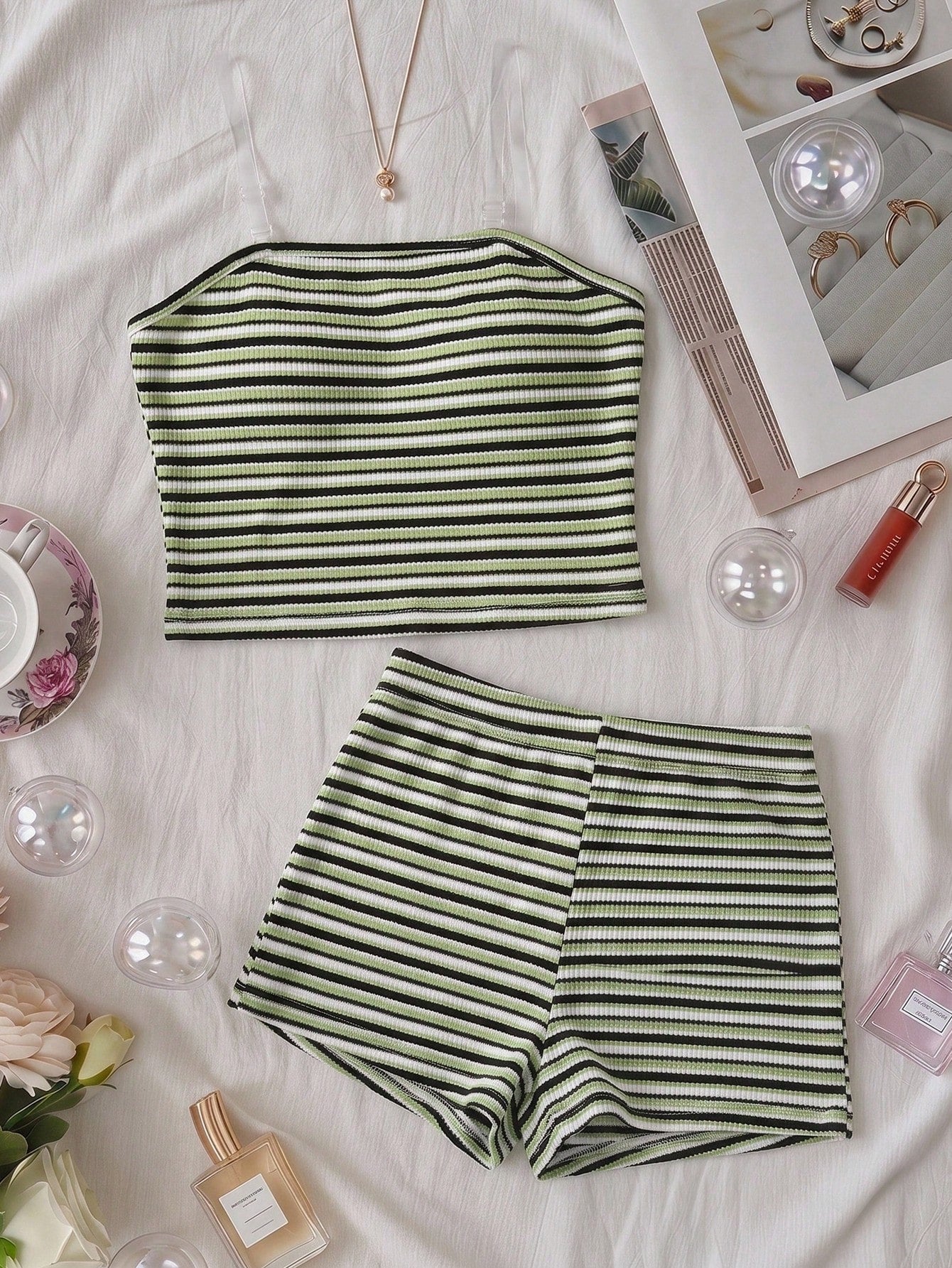 Tween girls black and white striped two-piece set featuring a spaghetti strap micro crop tank top with lettuce trim and ruffle hem paired with matching slim fit shorts.
