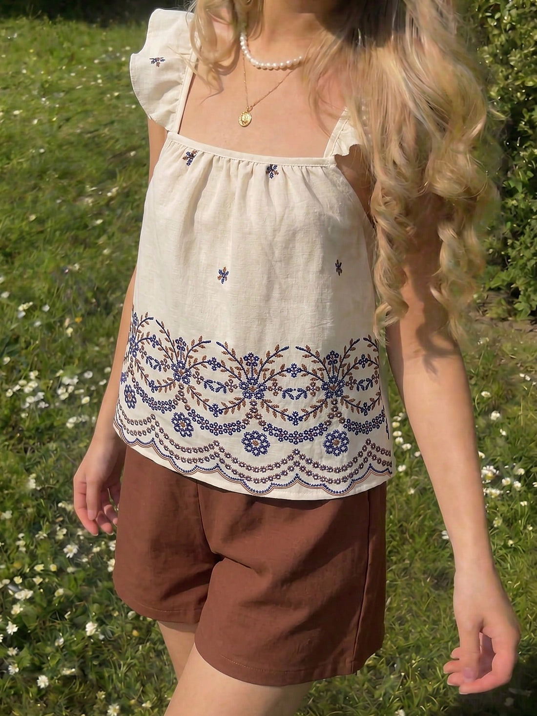Tween girls 2-piece bohemian outfit set in apricot featuring a square neck embroidered sleeveless camisole top and matching floral wide leg shorts.
