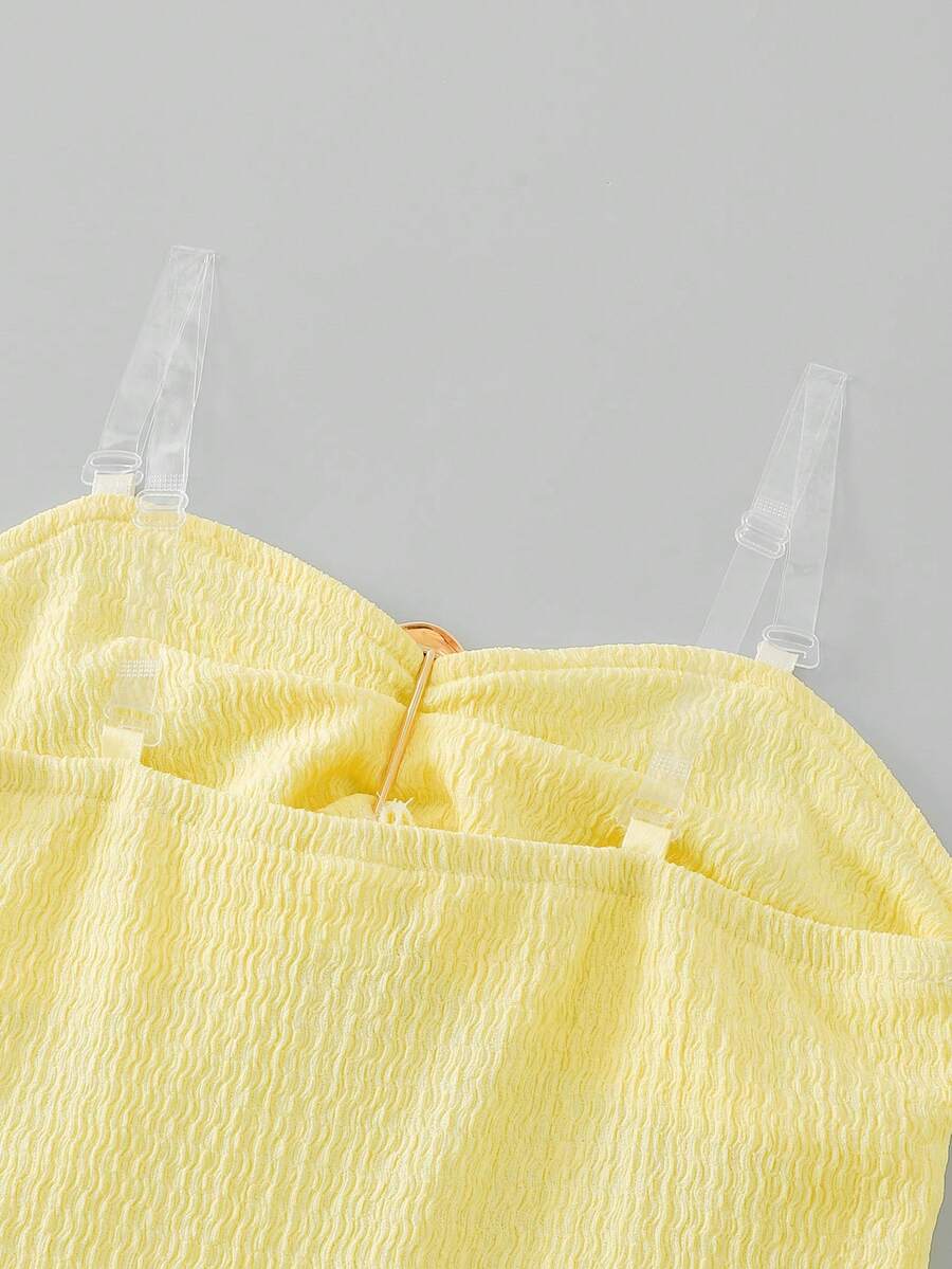 Tween girl black mini dress with halter neckline, backless design, tiered layer detail, high waist, flounce hem, and sleeveless slim fit.