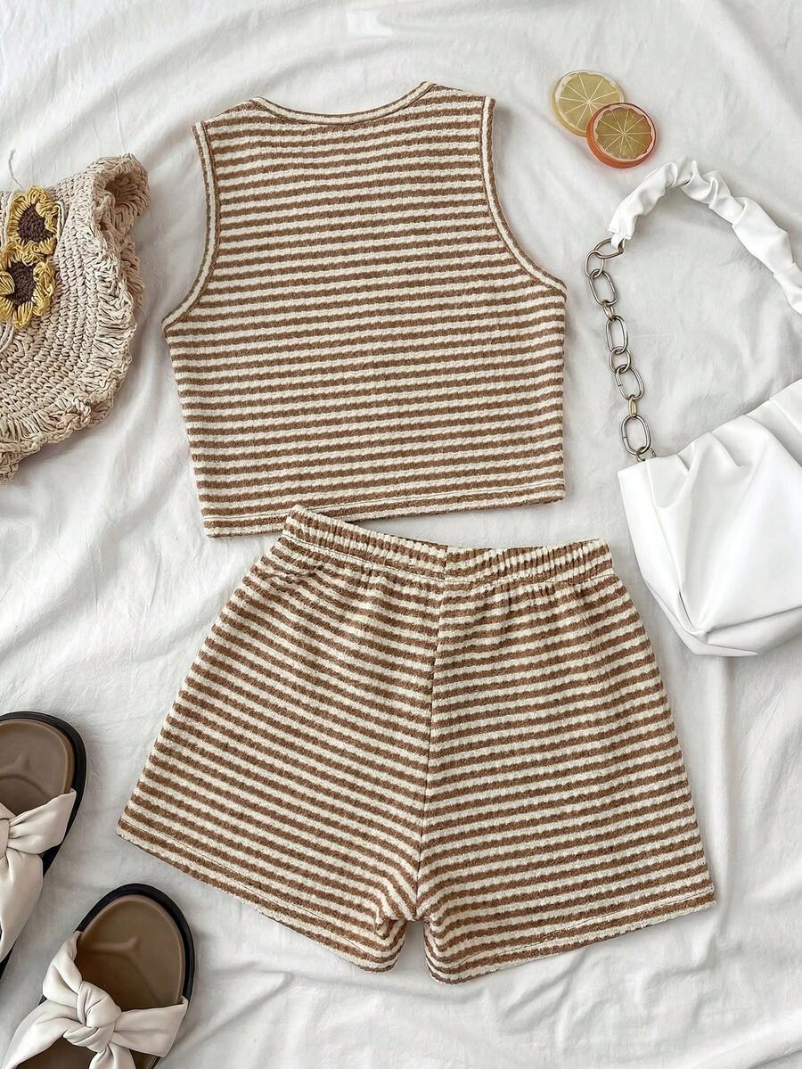 Tween girls black and white two-piece casual summer outfit featuring a rib-knit cropped top with round neck and matching shorts with contrast piping.