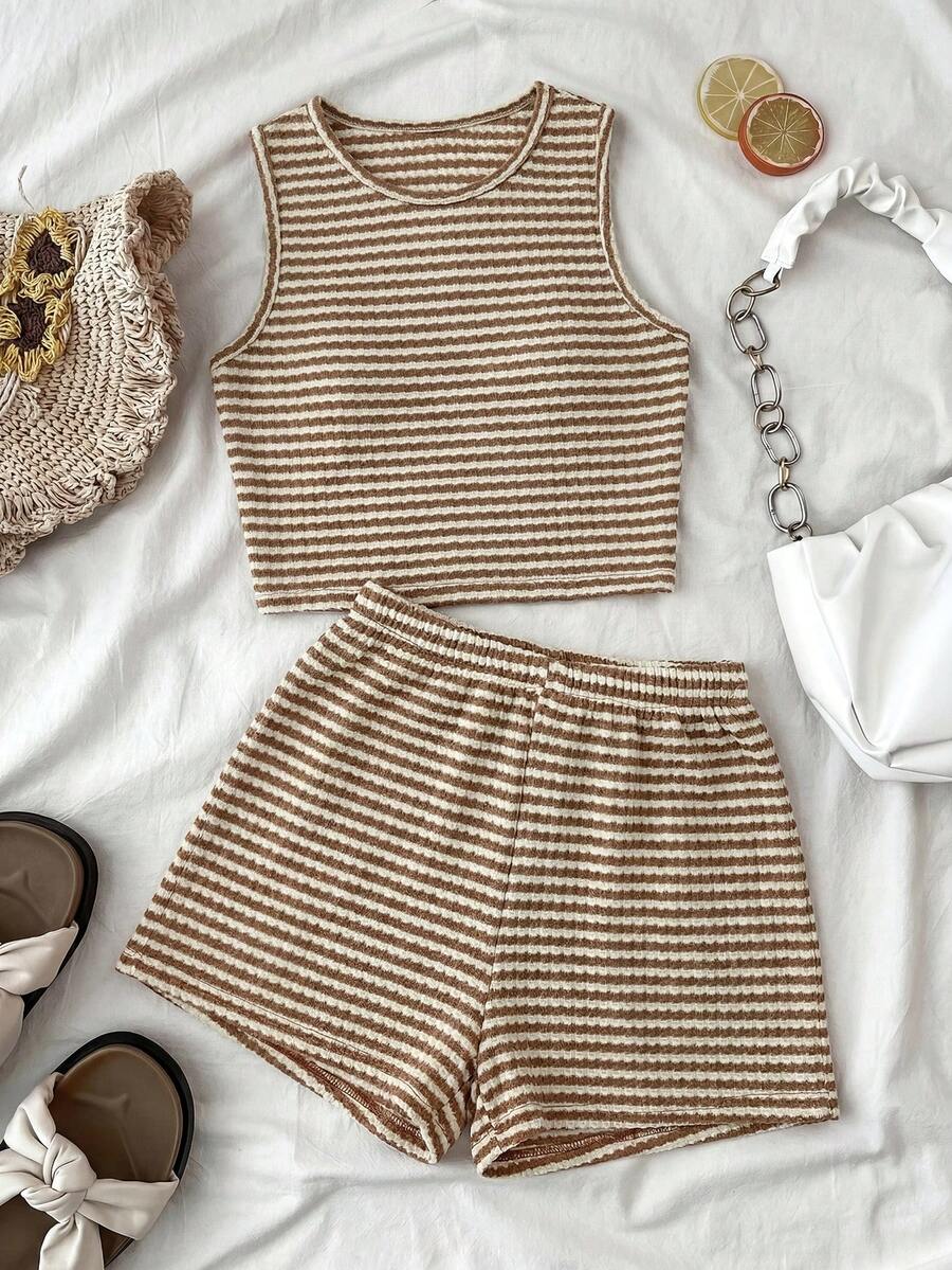 Tween girls black and white two-piece casual summer outfit featuring a rib-knit cropped top with round neck and matching shorts with contrast piping.