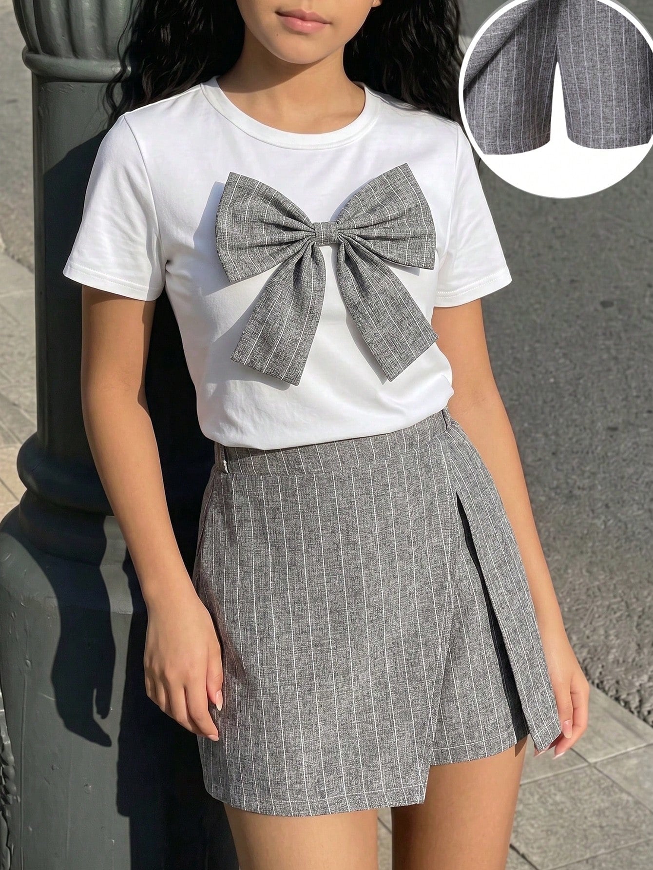 Tween girls 2-piece blue outfit featuring a short sleeve round neck t-shirt with a bow front detail and an asymmetric wrap skort.