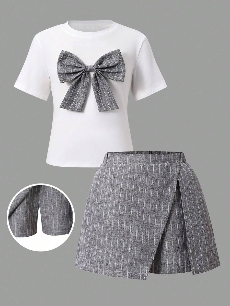 Tween girls 2-piece blue outfit featuring a short sleeve round neck t-shirt with a bow front detail and an asymmetric wrap skort.