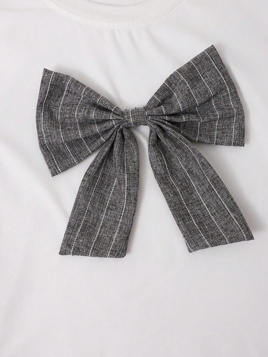 Tween girls 2-piece blue outfit featuring a short sleeve round neck t-shirt with a bow front detail and an asymmetric wrap skort.