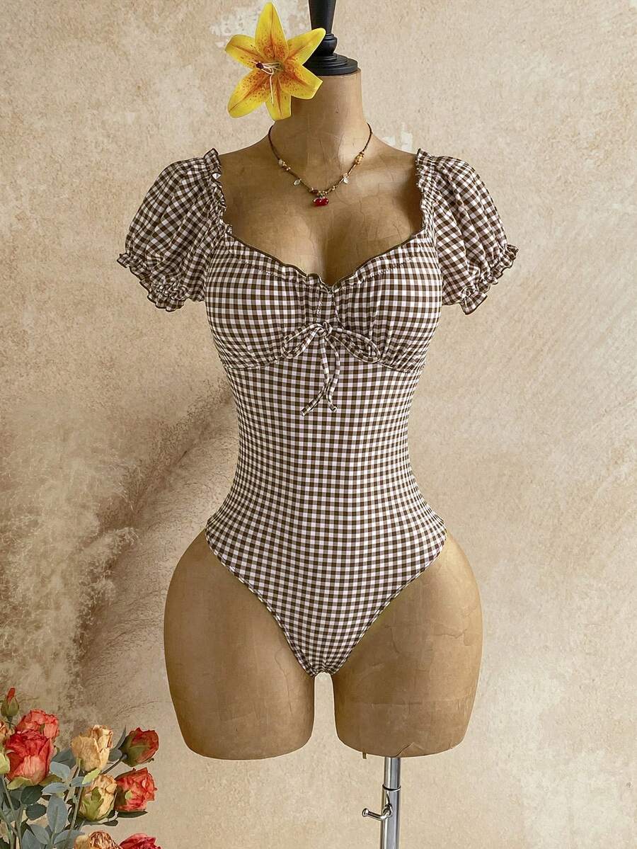 Multicolor plaid one-piece swimsuit for women featuring a sweetheart neckline, front twist detail, short sleeves, and removable padding.