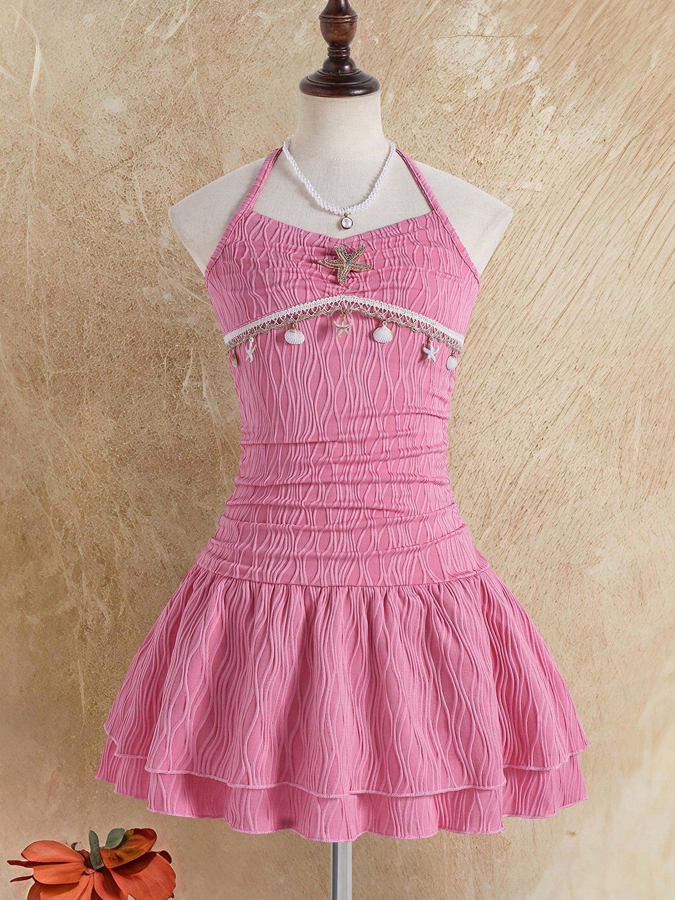 Tween girls apricot sleeveless halter mini dress with textured starfish and shell decor, shirred tiered layer, high waist, and flounce hem.
