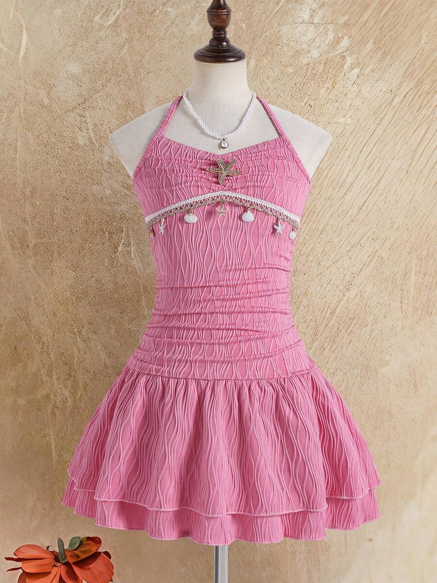 Tween girls apricot sleeveless halter mini dress with textured starfish and shell decor, shirred tiered layer, high waist, and flounce hem.