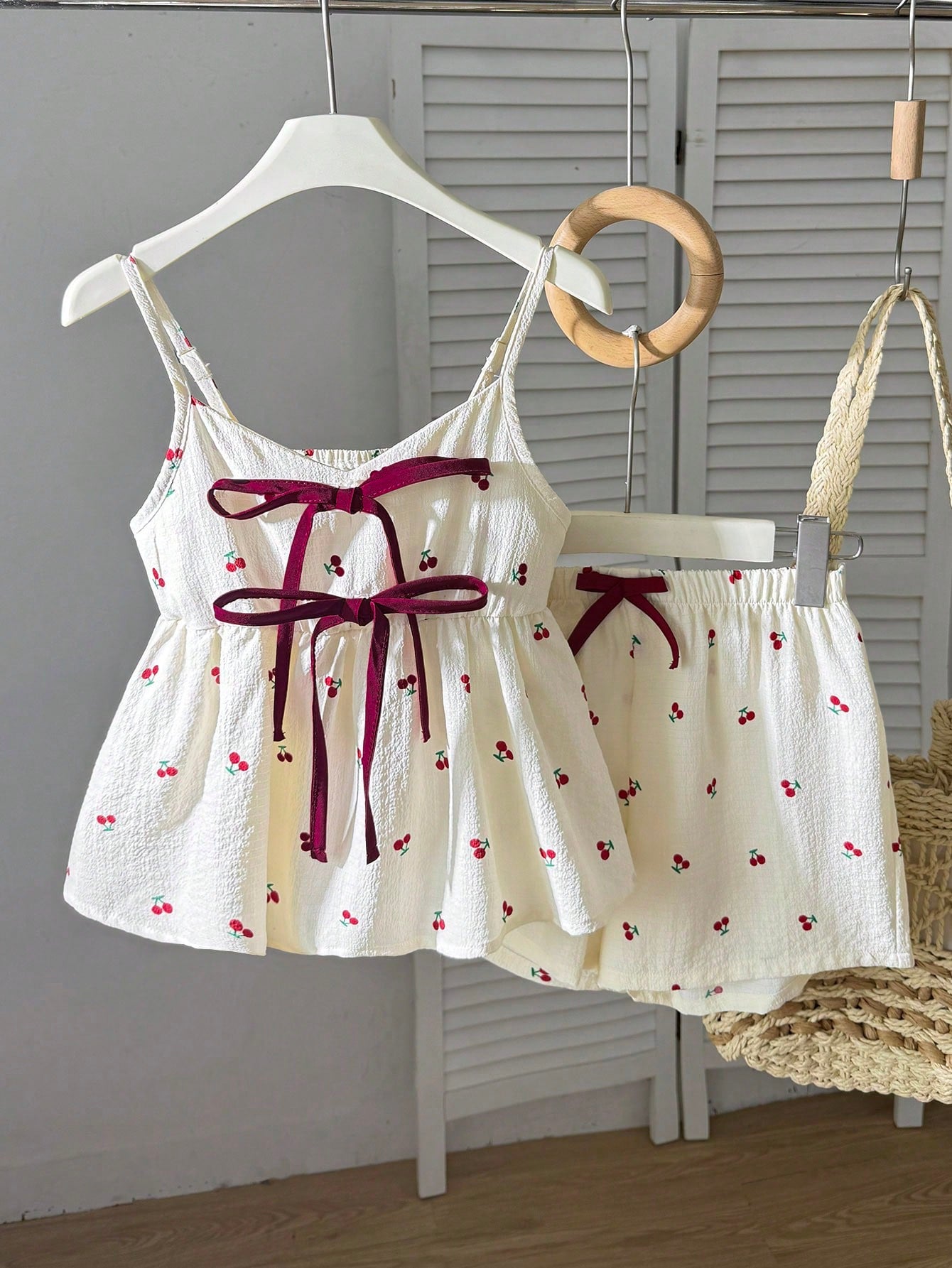 Tween girls 2-piece summer vacation set featuring a multicolored geometric print sleeveless camisole top with bow knot detail and matching elastic waist shorts.