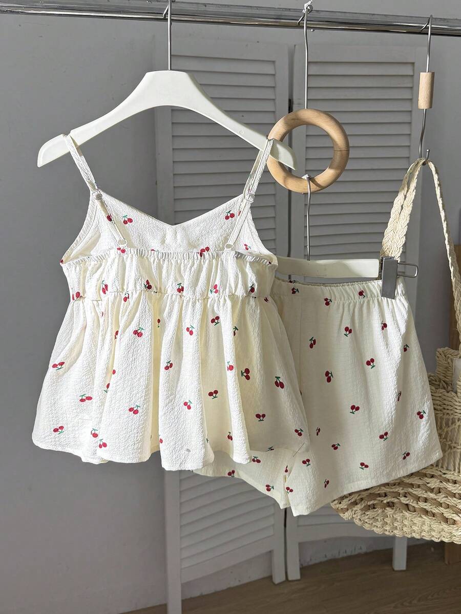 Tween girls 2-piece summer vacation set featuring a multicolored geometric print sleeveless camisole top with bow knot detail and matching elastic waist shorts.