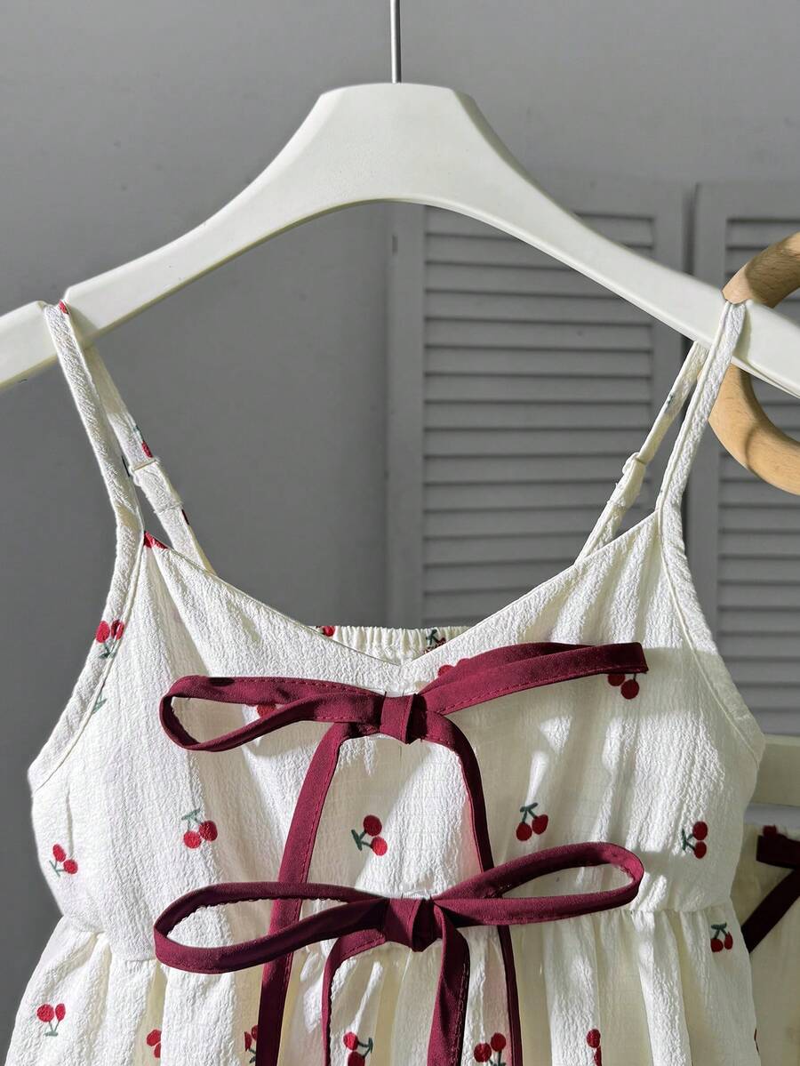 Tween girls 2-piece summer vacation set featuring a multicolored geometric print sleeveless camisole top with bow knot detail and matching elastic waist shorts.
