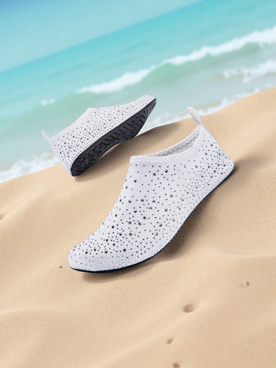 White children's slip-on water shoes with breathable mesh upper, soft EVA insole, non-slip TPR outsole, and rhinestone accent.