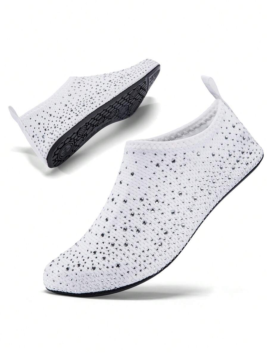 White children's slip-on water shoes with breathable mesh upper, soft EVA insole, non-slip TPR outsole, and rhinestone accent.