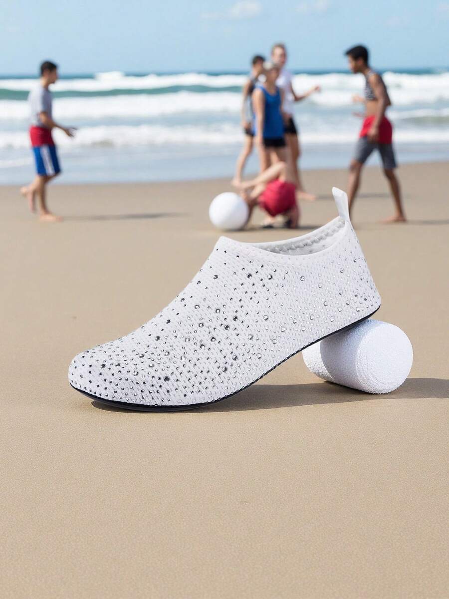 White children's slip-on water shoes with breathable mesh upper, soft EVA insole, non-slip TPR outsole, and rhinestone accent.