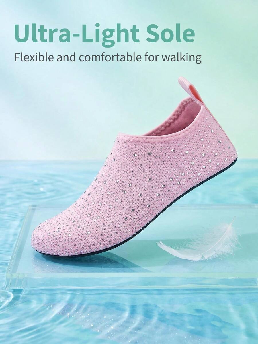 White children's slip-on water shoes with breathable mesh upper, soft EVA insole, non-slip TPR outsole, and rhinestone accent.