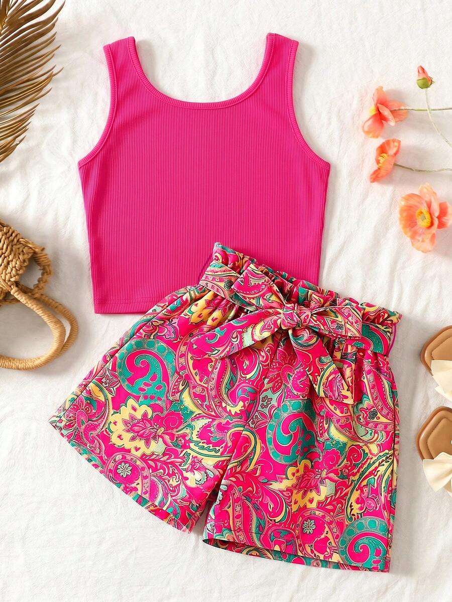 Tween girl wearing a casual 2-piece set featuring a black rib-knit scoop neck tank top and leopard print paperbag waist shorts with a matching belt.