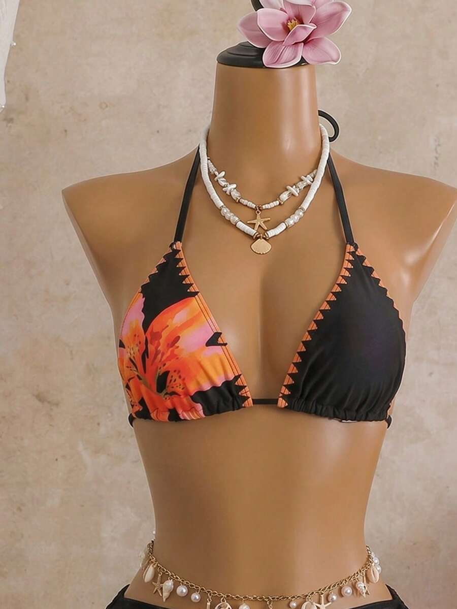 Women's black 3-piece bikini set featuring a halter triangle top with removable padding, high-waisted bottoms, and a knee-length mesh skirt with tie details.