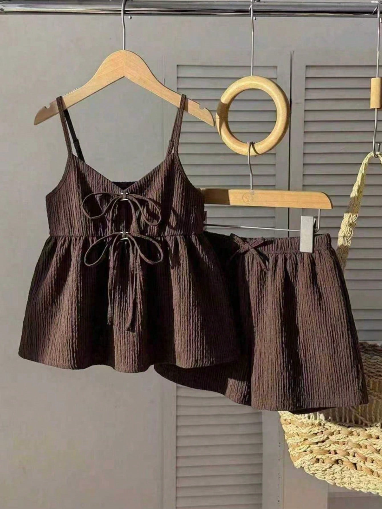 Tween girl 2-piece summer set with a black and white sleeveless striped spaghetti strap tank top with ruffle details and matching casual shorts.