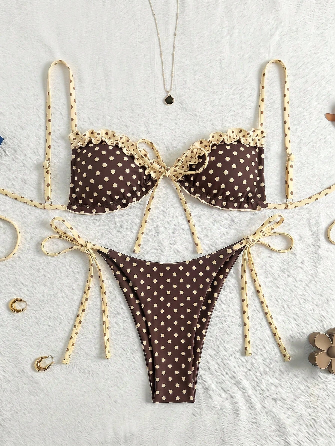 Women's beige two-piece bikini set featuring a wireless top with removable padding, spaghetti straps, tie back detail, and low waist hipster swimsuit bottoms.