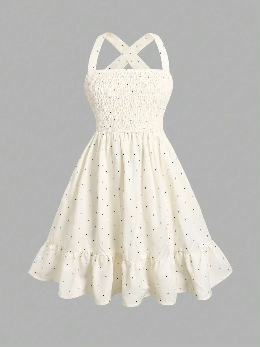 Pink sleeveless tween girls vacation dress with all-over fruit and vegetable print, strap neckline, belted high waist, cut-out detail, and flared ruffle hem.