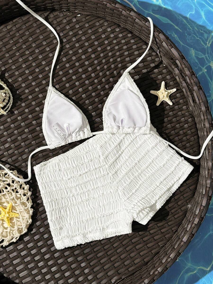 Women's apricot two-piece swimsuit set with a halter tie-back top and matching high stretch shorts.
