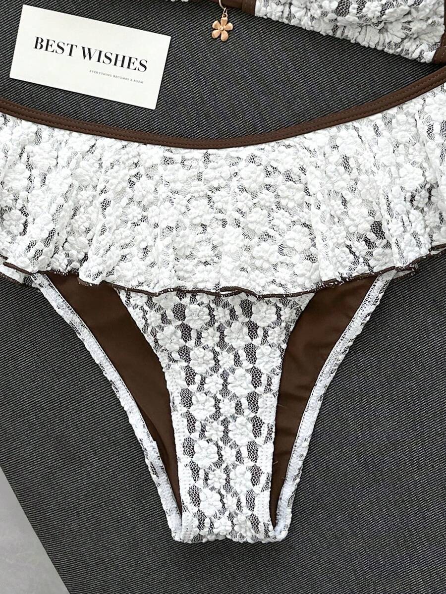 Women's 70s retro black and white polka dot bikini set featuring a halter triangle top and ultra low waist bottoms.