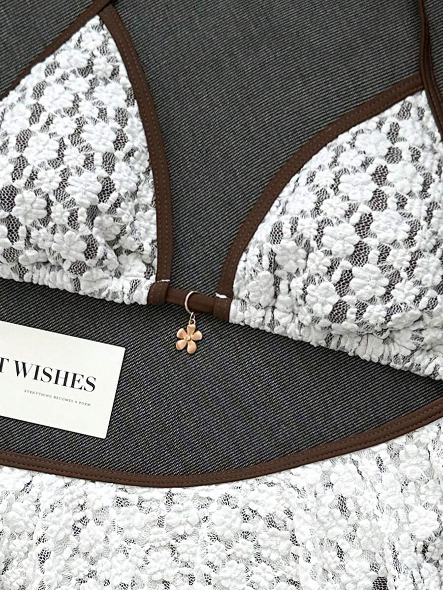 Women's 70s retro black and white polka dot bikini set featuring a halter triangle top and ultra low waist bottoms.