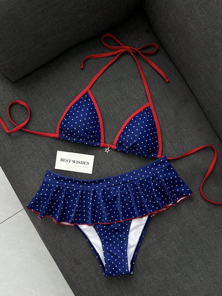 Women's 70s retro black and white polka dot bikini set featuring a halter triangle top and ultra low waist bottoms.
