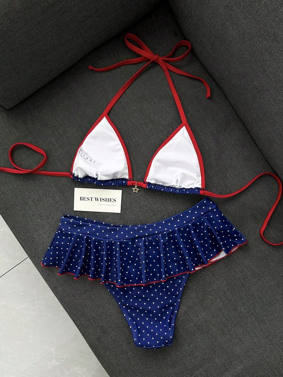 Women's 70s retro black and white polka dot bikini set featuring a halter triangle top and ultra low waist bottoms.