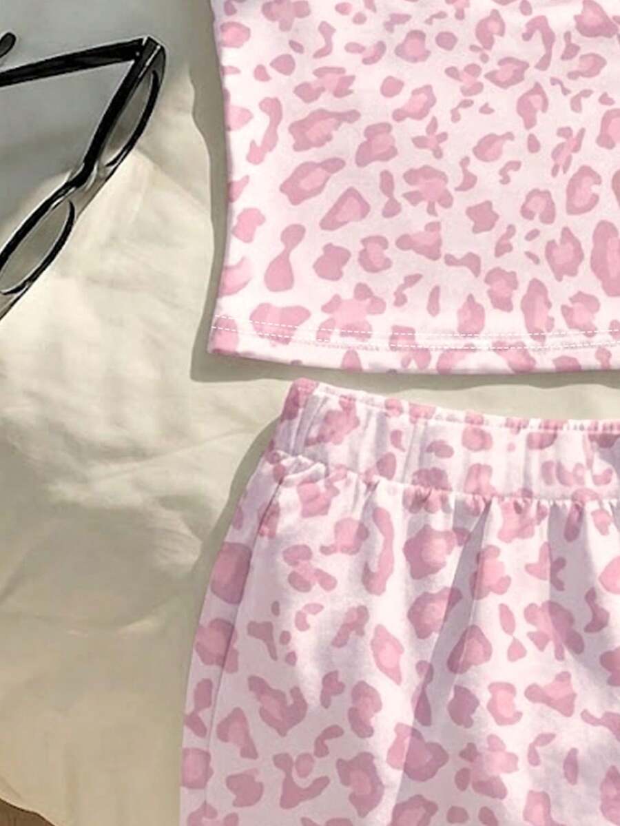 Tween girls summer 2-piece Hawaiian style outfit featuring a graphic print spaghetti strap camisole top with contrast piping and matching casual shorts.