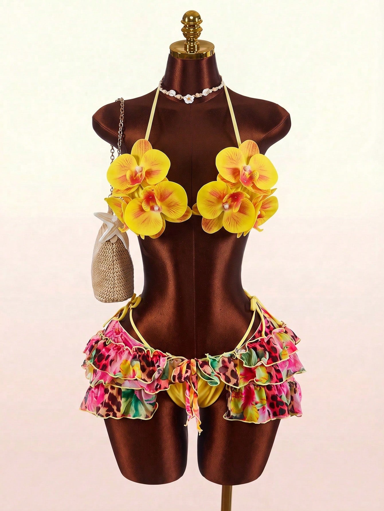 Women's 3-piece blue bikini swimwear set featuring a crop top with 3D rose accents, tie back detail, spaghetti straps, and tie-side bottoms.