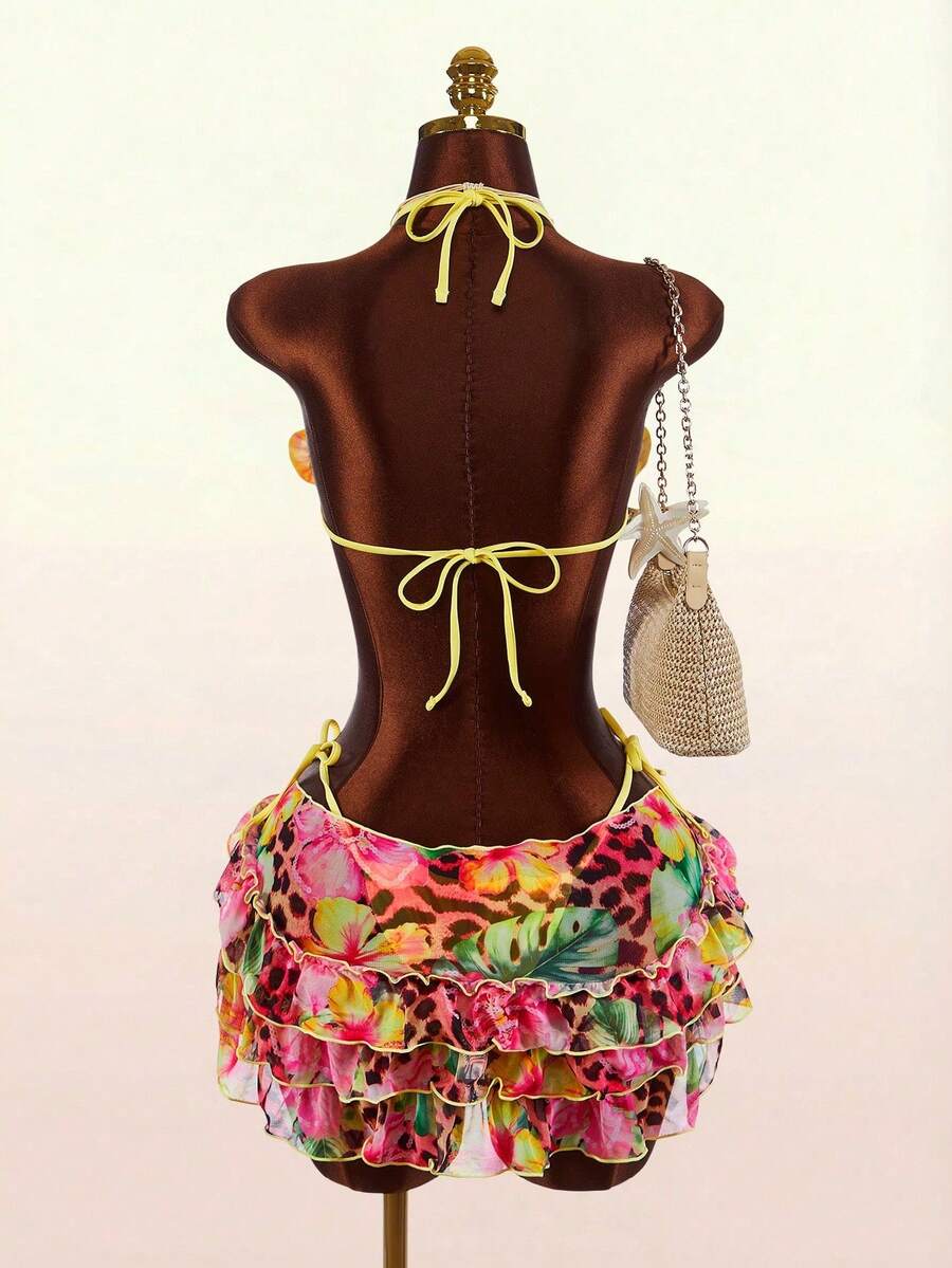 Women's 3-piece blue bikini swimwear set featuring a crop top with 3D rose accents, tie back detail, spaghetti straps, and tie-side bottoms.