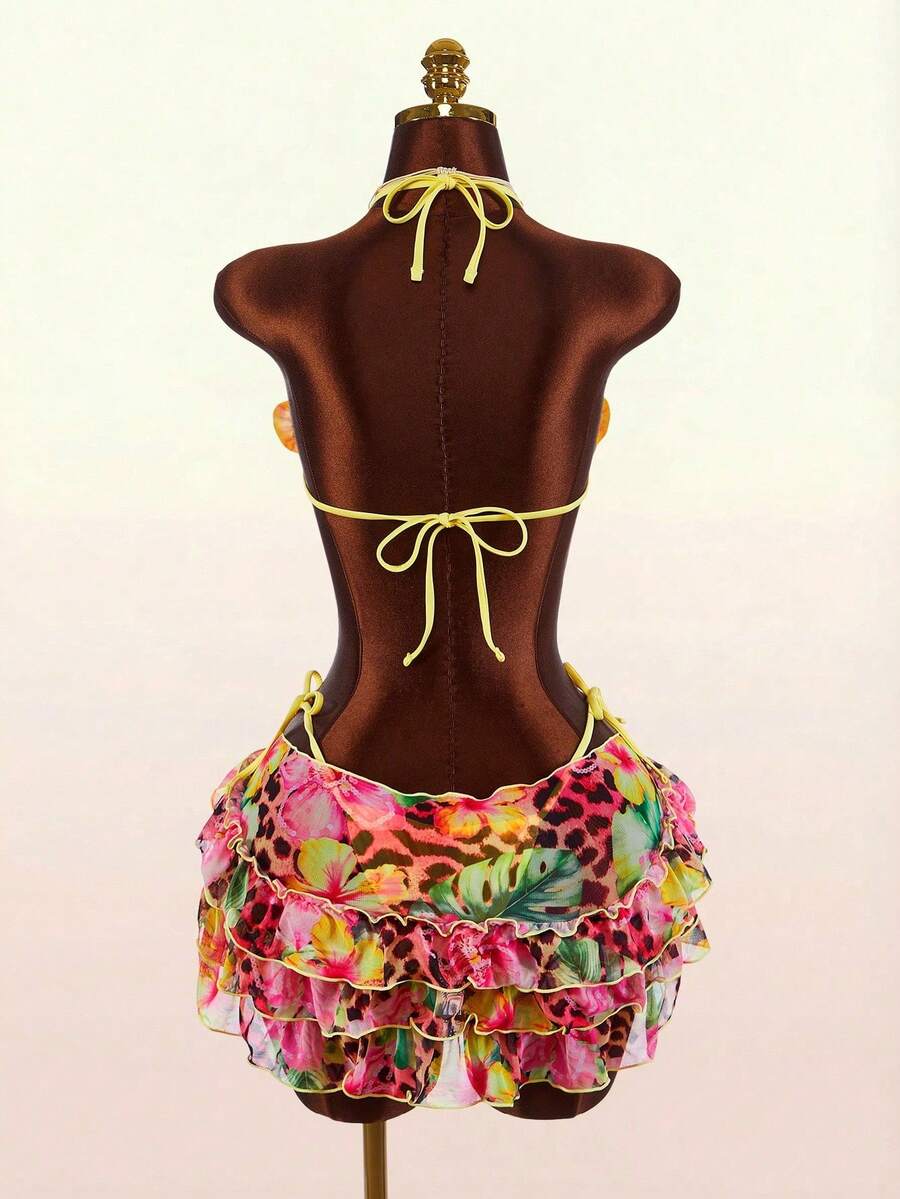 Women's 3-piece blue bikini swimwear set featuring a crop top with 3D rose accents, tie back detail, spaghetti straps, and tie-side bottoms.