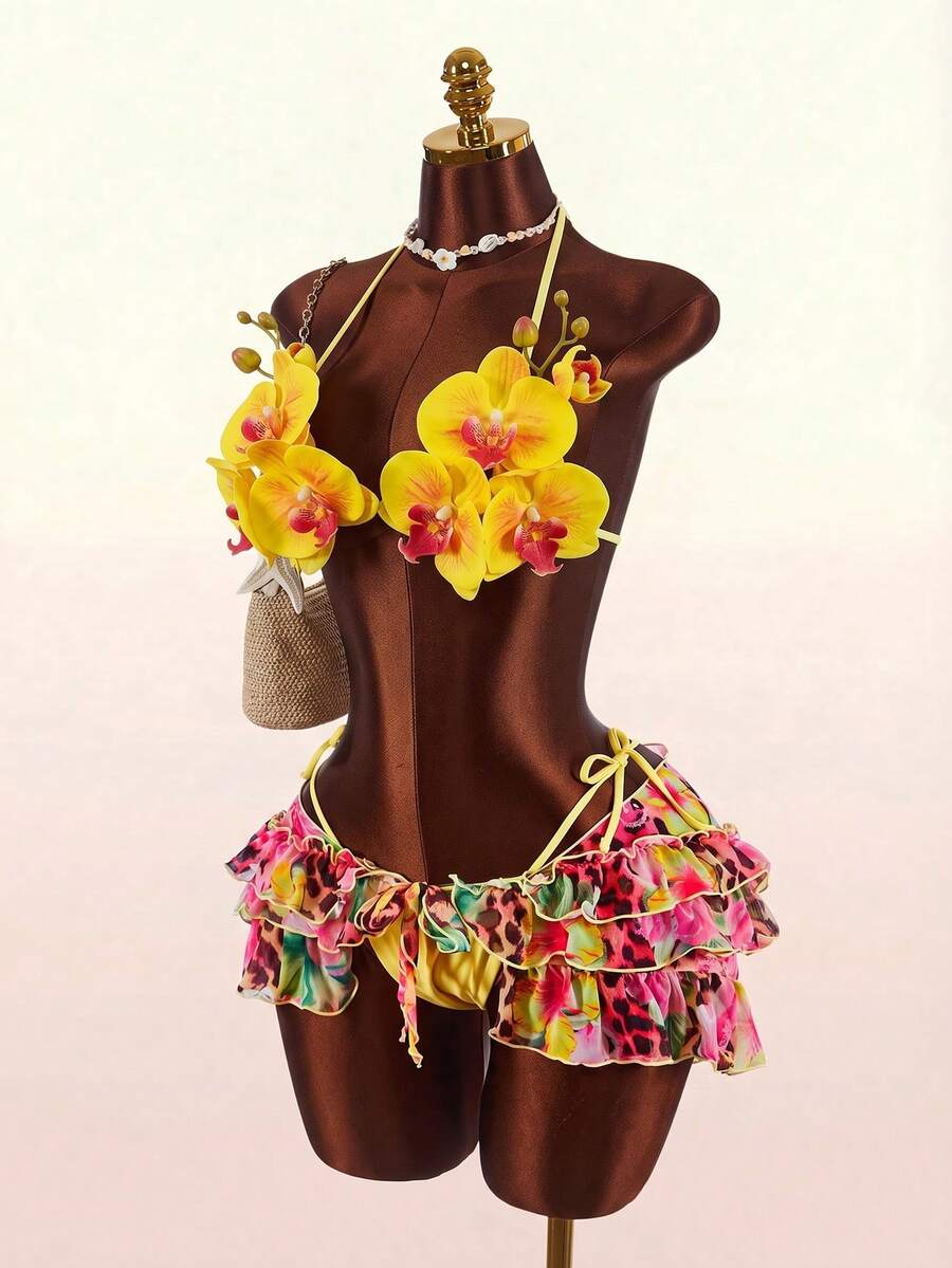 Women's 3-piece blue bikini swimwear set featuring a crop top with 3D rose accents, tie back detail, spaghetti straps, and tie-side bottoms.