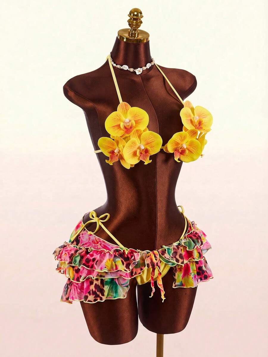 Women's 3-piece blue bikini swimwear set featuring a crop top with 3D rose accents, tie back detail, spaghetti straps, and tie-side bottoms.