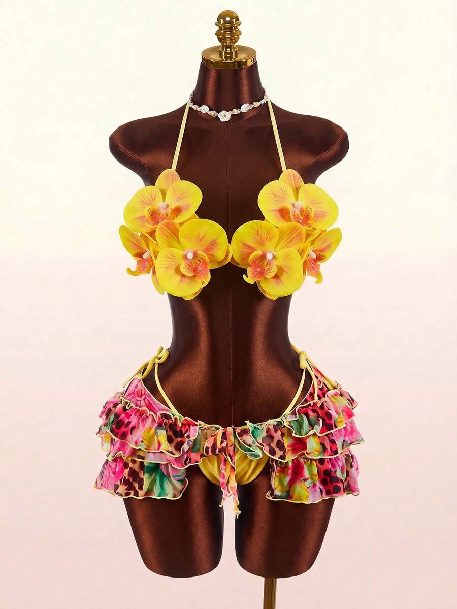 Women's 3-piece blue bikini swimwear set featuring a crop top with 3D rose accents, tie back detail, spaghetti straps, and tie-side bottoms.