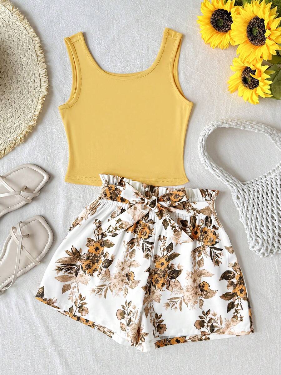 Tween girl wearing a casual 2-piece set featuring a black rib-knit scoop neck tank top and leopard print paperbag waist shorts with a matching belt.