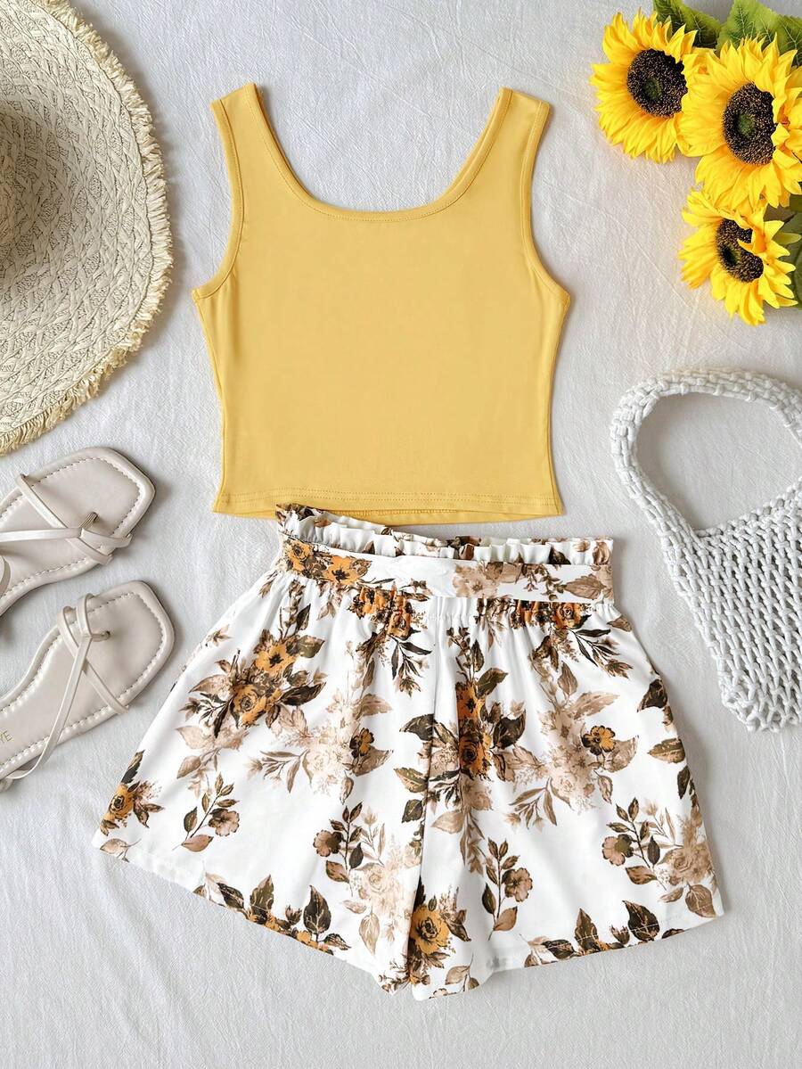 Tween girl wearing a casual 2-piece set featuring a black rib-knit scoop neck tank top and leopard print paperbag waist shorts with a matching belt.