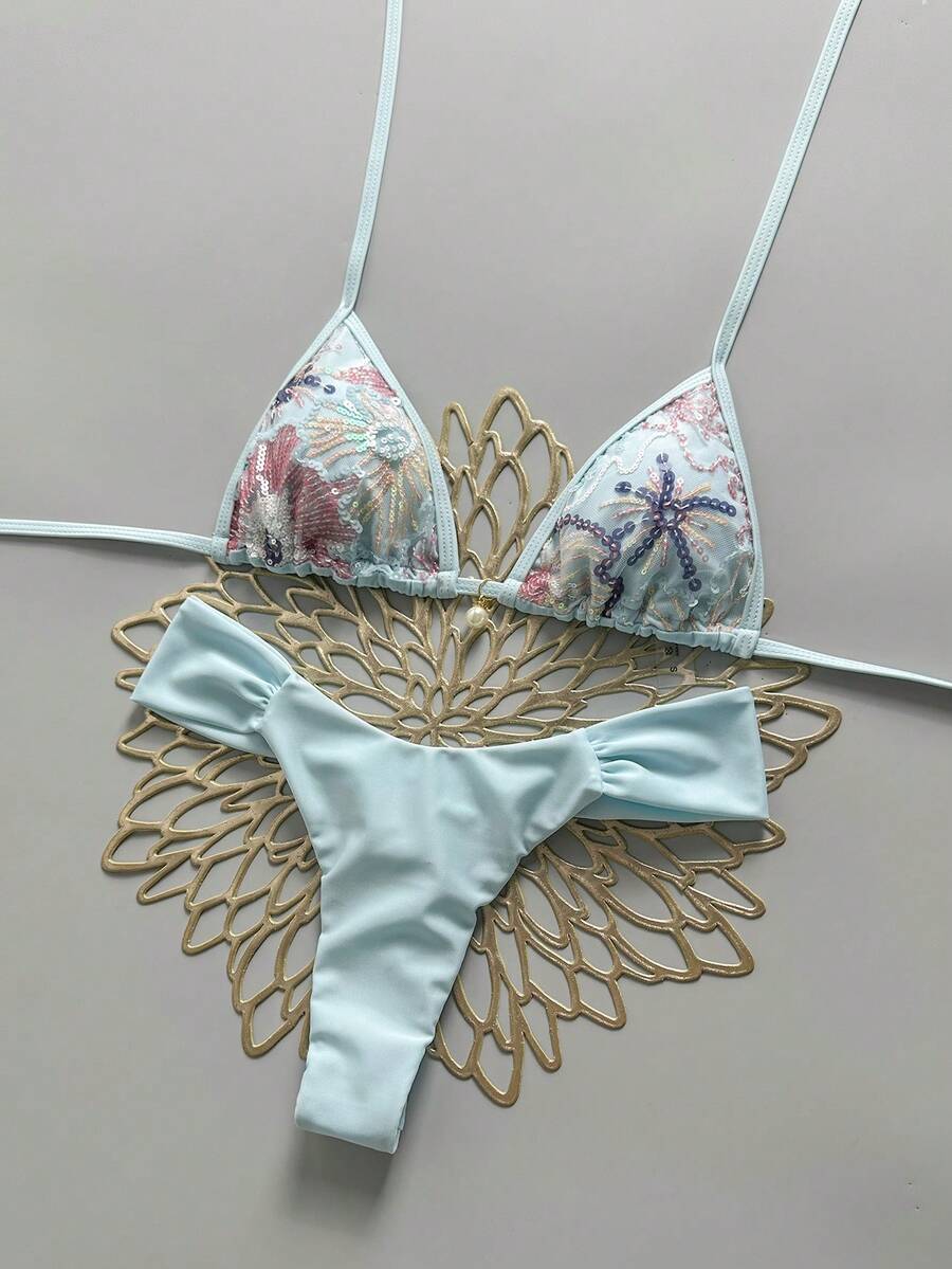 Women's 2-piece triangle cup bikini set in solid color featuring woven pearl shell decoration, halter neckline, and high-waist side-tie ruched bottoms.