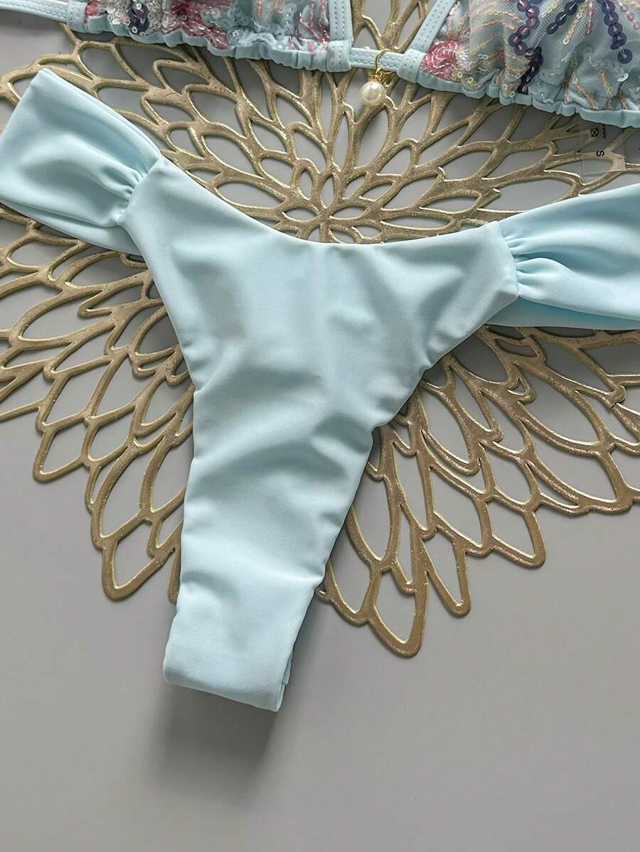Women's 2-piece triangle cup bikini set in solid color featuring woven pearl shell decoration, halter neckline, and high-waist side-tie ruched bottoms.